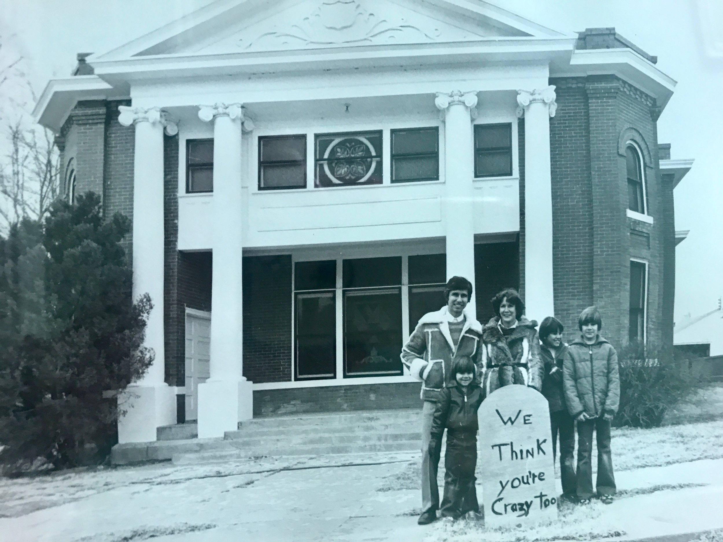 The Abraham Family posing with their 'crazy' sign