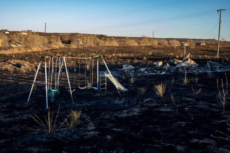 A melted swing set and a pile of metal and ash are all that’s left of a trailer homestead in Fritch. (Texas A&M AgriLife photo by Sam Craft)