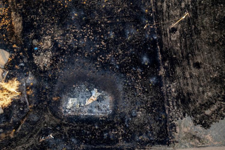 A pile of metal and ash sitting in a charred field is all that remains of a trailer destroyed by fire in Fritch. (Texas A&M AgriLife photo by Sam Craft)