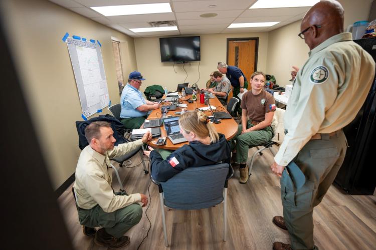 Texas A&M Forest Service Director Al Davis, right, and Associate Director of Forest Resorce Protection and Fire Chief Wes Moorehead, left, prepare for a morning briefing. (Texas A&M AgriLife photo by Sam Craft)