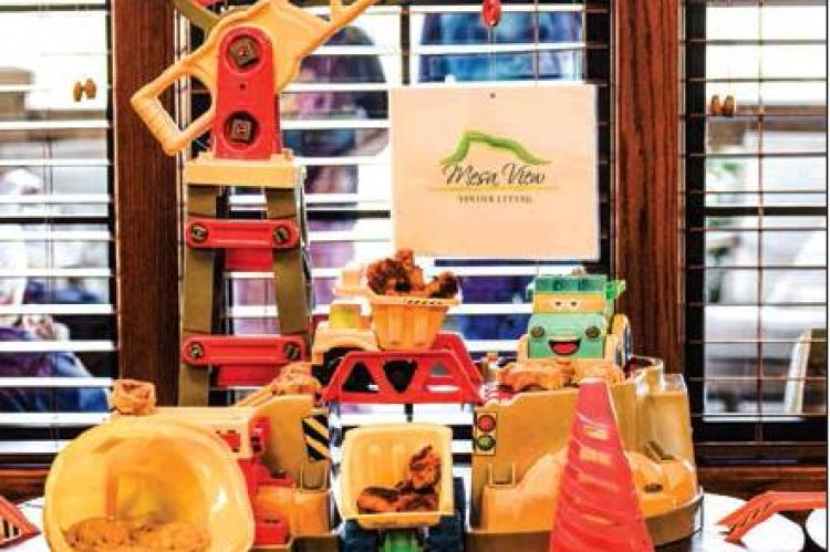 The HCH District dietary staff prepared a charming spread of construction-related treats for the groundbreaking reception, featuring yellow hardhats, orange safety cones, dirtcake, toy trucks loaded with malted milkballs, and more.