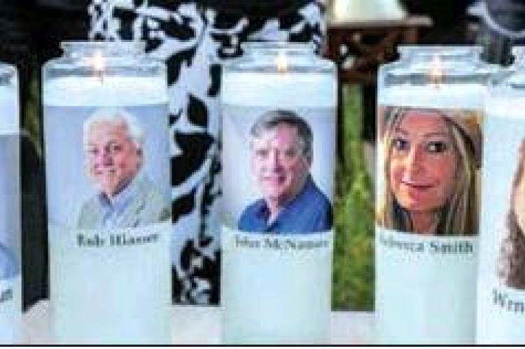 Candles with the faces of the five employees who were killed were used at a gathering of mourners for the employees killed in the Capital Gazette newsroom, Annapolis, Maryland. PHOTO Y KARL MERTON FERRON | THE BALTIMORE SUN