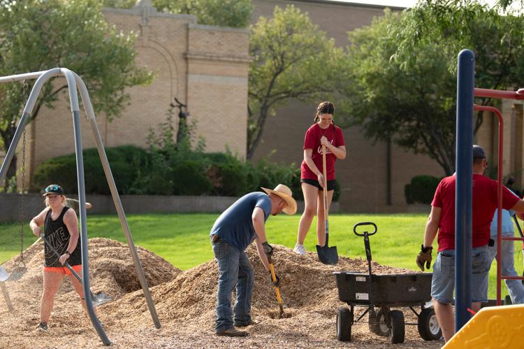 Volunteers clean up the playground at Baker Elementary School