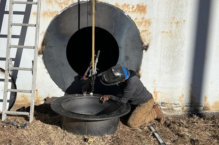 A modified and enlarged service entry for the storage tank 