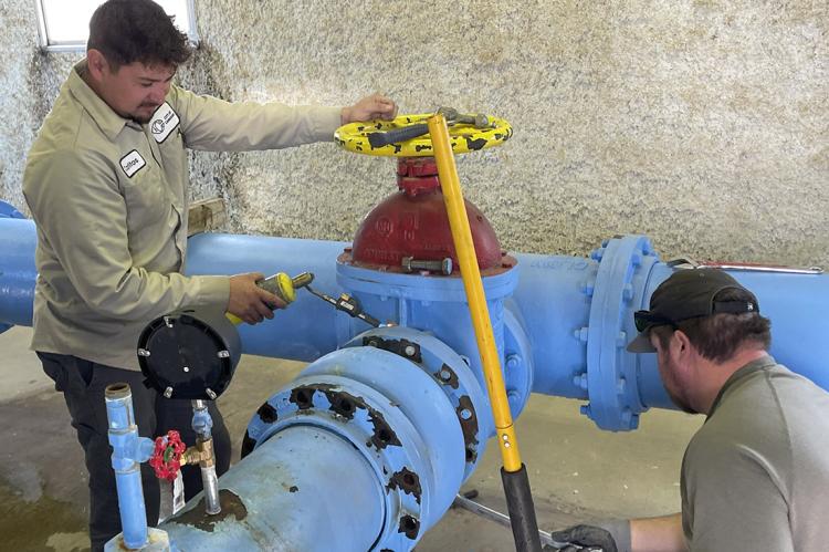 City Water Department workers making repairs inside the pump house