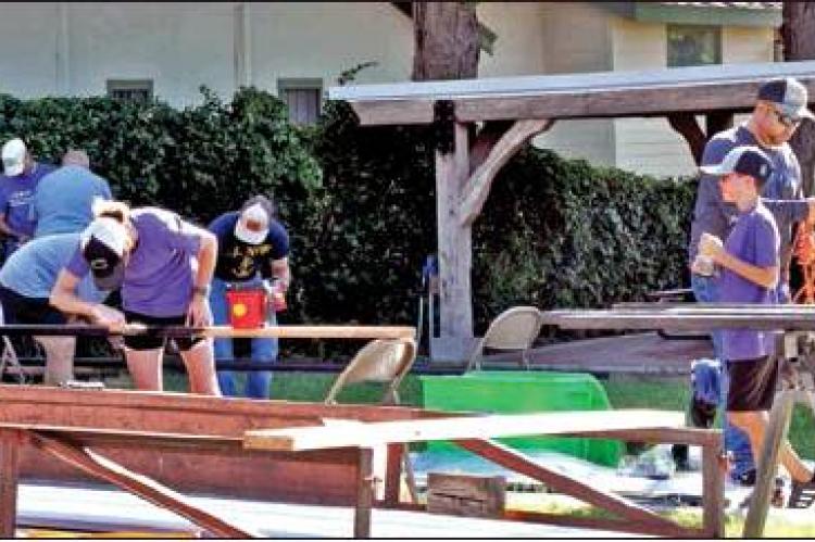 A crew of volunteers painted trim and baseboards outside of the Cat’s Paw while others were at work inside installing a new floor and corrugated wainscotting.