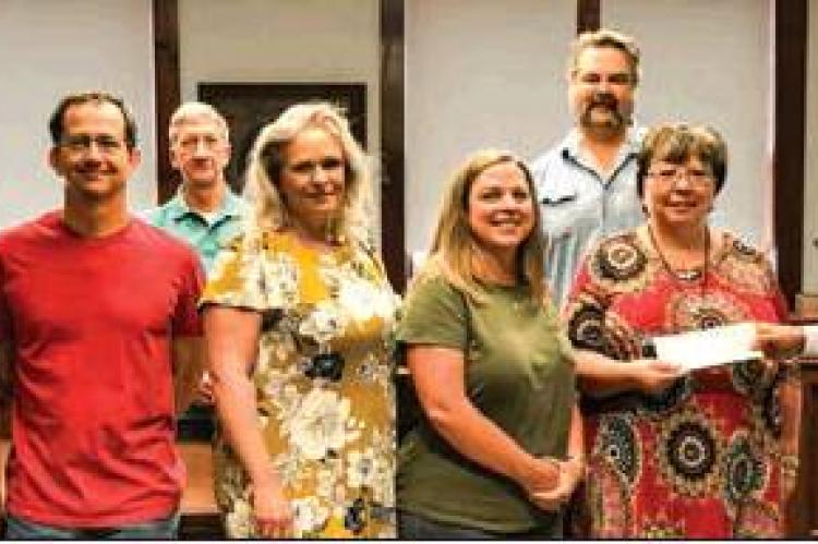 RACHEL’S LITTLE HOUSE: Canadian Area Legacy Fund rep. George Briant (at right in photo) presents a $7,000 check to Rachel’s Little House; (left to right) CALF reps. Sherye Talley, Larry Smith, and Terrill Bartlett; RHL board members, Wendy Wright, Julie Harper, and Britt Sturgeon; and RLH Director Cesali Ericson.
