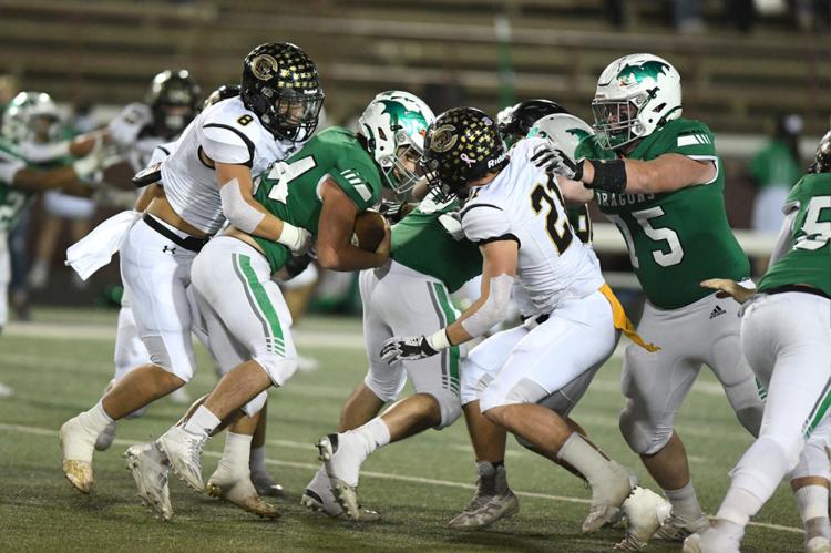 Ethan Jackson (8) and Hayze Hufstedler (21) put brakes on Ethan Sanchez (24)