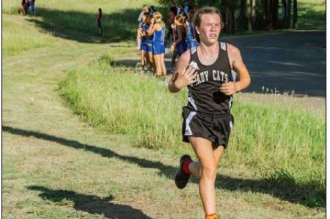 In photo above, Konner McClendon legs out lead for Canadian Middle School Cross Coun try.