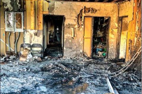 In photos at right, the exterior and interior of the Shrader home’s garage, which sustained the most fire damage.