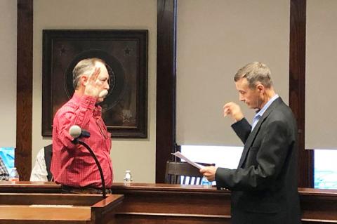 County Judge George Briant administers oath of office to Sheriff Brent Clapp