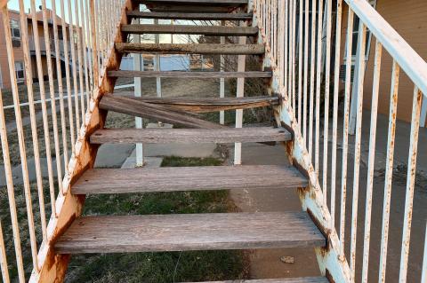 Rusted and rotting outdoor staircases at the Canadian Apartments are just one indication of the public danger the unsecured property poses