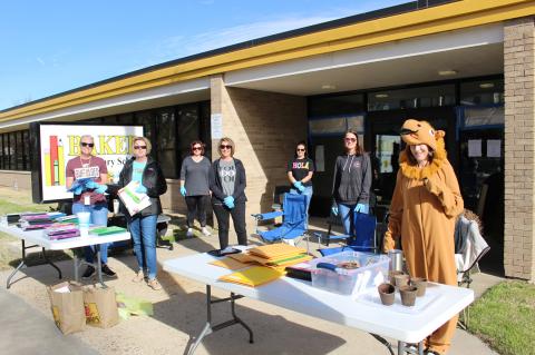 BES staff members pass out remote learning packets to K-5 students Wednesday.