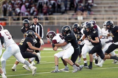  Senior lineman Saul Escamilla wraps up the Hornet runner, as a swarm of Wildcats prepare to lend a hand.