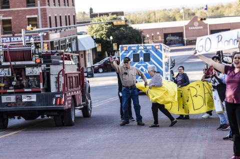 Monday afternoon, Band boosters and supporters lined Main Street and unfurled a banner for the bus to break through. 