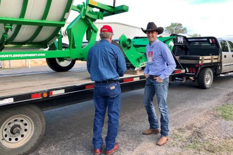 A potential customer talks to Hustler Equipment USA's Lance Paskewitz about new equipment on display at the beef conference trade show