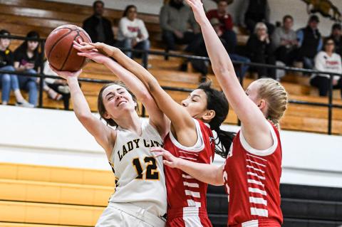 Briley Merket (12) fights to go take the shot vs. Friona