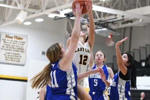 JV Brooklyn Beedy (12) fights for air in a crowd of Wildorado Mustangs