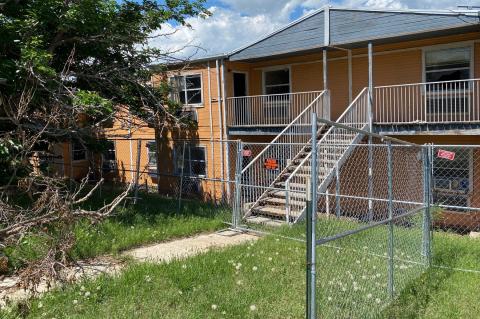 A hazard to public safety, the apartments were finally barricaded behind chain link fence this summer.