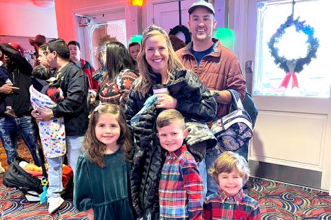 Charlie and Kristen Mann and family waiting for their visit with Santa at the Palace