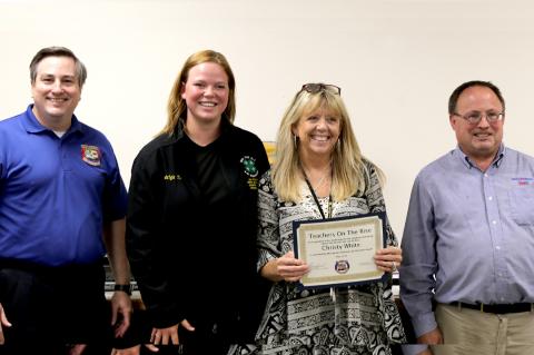 Baird Bread representatives Shane Sumrow (left) and Brad Smith (right) with Haeleigh Thompson and Teacher on the Rise Christy White