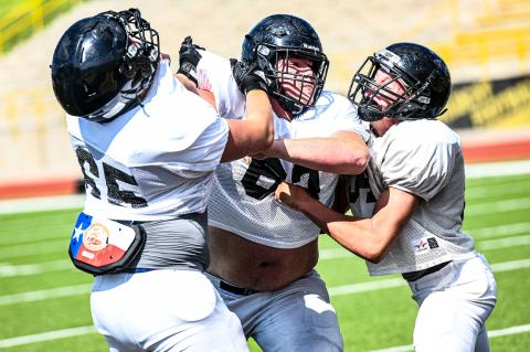 No. 63 Corbin Throgmorton (center) in Monday afternoon workouts