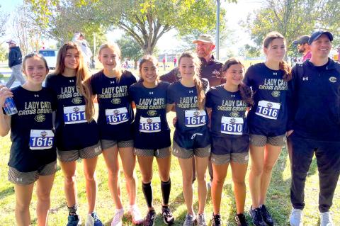 Lady Cat cross-country team: Konnar McClendon, Brooklyn Beedy, Arionna Black, Elizabeth Guerrero, Payton Lee, Kathy Aragon, Ella Walser, and Coach Aaron Marks