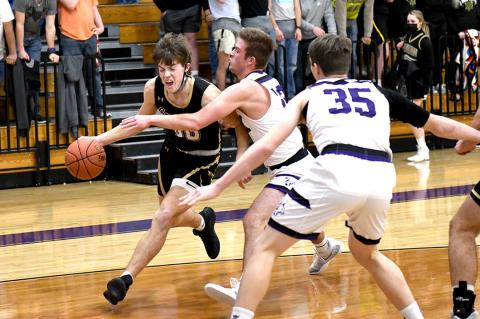 Josh Culwell (00) fights for a shot at the bucket in the Cats’ win over Spearman