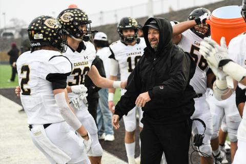 Jack (#@) and Bill (#30) Koetting celebrate with their dad, Head Football Coach Chris Koetting