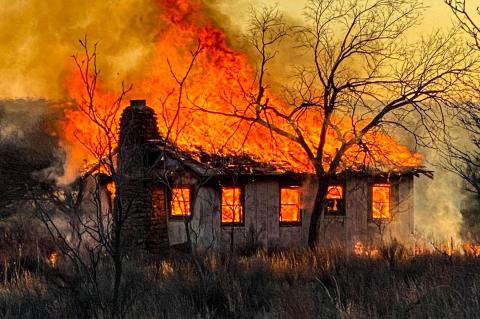 Charlie Rankin captured this photo of the cabin engulfed in flames before firefighters arrived Saturday