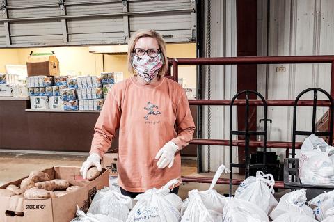 Volunteers prep bags for distribution at the Hemphill County Exhibition Center.