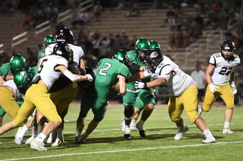 George Abraham (No. 5) and Fernando Perez (No. 60) stop Cameron Baker (No. 2).