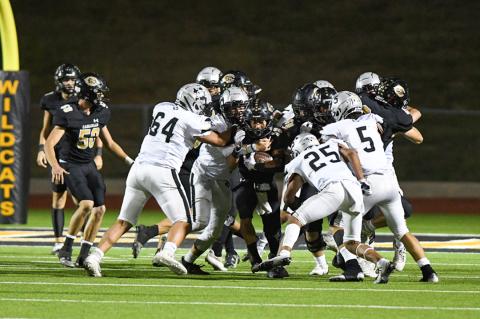 Isay Ramirez (10) bulls his way out of a pack of Randall Raiders