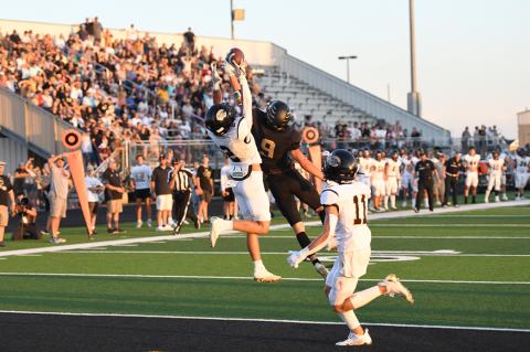 Bushland defender tips a Camren Cavalier-to-Trace Mitchell (2) pass as Preston Miller (11) steps in to assist