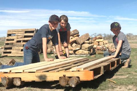 Ben Bussard, Bridger and Parker Burrus construct a homemade raft, and float it down Wolf Creek 