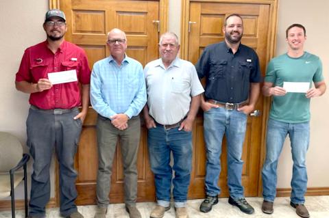 Gem City volunteer firefighter Travis Macias (at left) and Canadian volunteer firefighter Bryan Bartlett (at right) receive donations from Texas Farm Bureau Board Members Jim Haley, Kenneth Wicker and Doug Crouch.