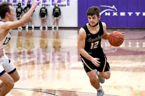Jake Krehbiel (12) drives the ball downcourt