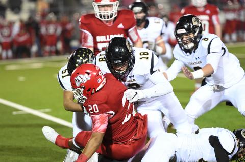 Canadian’s Jorge Dominguez (#51), Brice Wilkinson (#18) and Ethan Jackson (#8) shut down Coahoma running back Isaac Murillo (#20).  