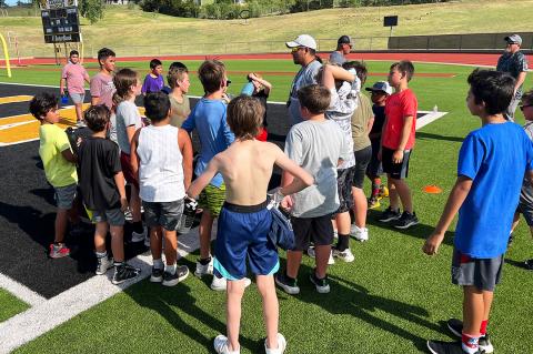 Robert Reyes coaches up the players during a hydration break