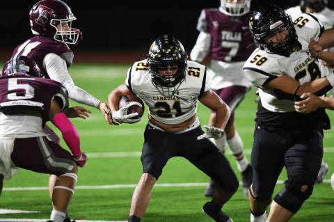 Canadian's Nehemiah Harris (58) makes a hole for Kaden Crooks (21), who had 12 carries for 77 yards and three TDs Friday night