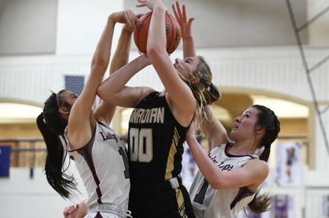 Kennedi Cook (00) draws some heat as she goes up for the basket