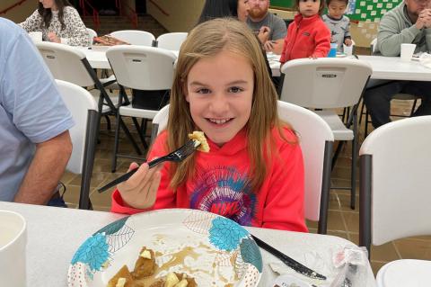 Kota Shrader with a forkful of delicious pancakes and syrup