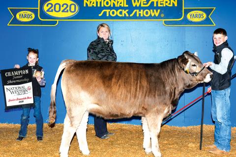 Colt Pittman with sister, Cambree, and the judge after receiving his showmanship award.