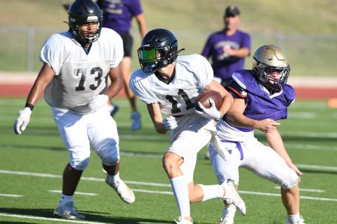 In Canadian's scrimmage against the Panhandle Panthers, running back Preston Miller slips one tackle and looks for cover from his O-lineman Javier Cardenas.