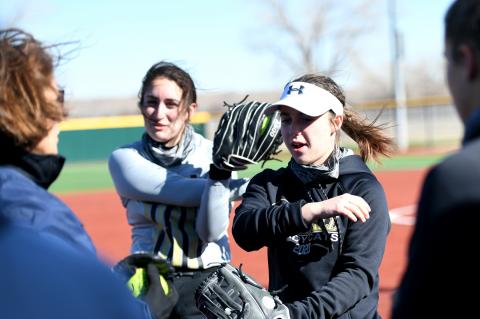 Lady Cat Head Coach Cay Parnell gives players Addie Bylinowski and Ashleigh Rowden tips before a scrimmage