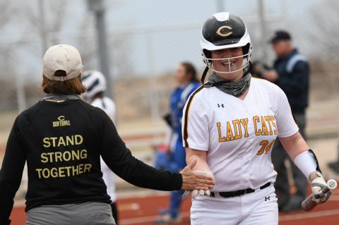 Slugger Haeleigh Thompson and Coach Cay Parnell trade a low-five to celebrate her out-of-the-park homer in Tuesday evening's loss to Childress here at home. 