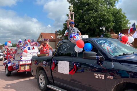 The Sugar Shack's Mike (holding trophy) and Jamie Jernigan garnered the coveted Sweepstakes Award with a giant birthday cake celebrating Happy Independence Day