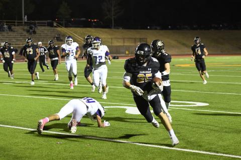 In a standout performance Friday, freshman wide receiver Luke Flowers dodges a tackle on his way downfield.