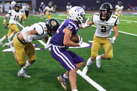 Defensive backs Baldo Garcia (15) and Trace Mitchell (2) cut off the run