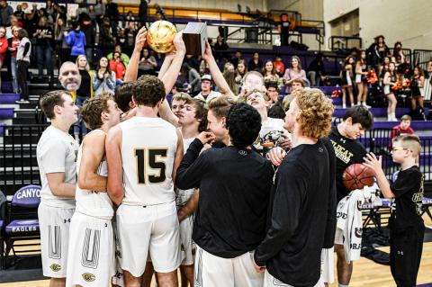 Canadian Wildcats loft their bi-district playoff trophy high following Monday's victory at Canyon High School